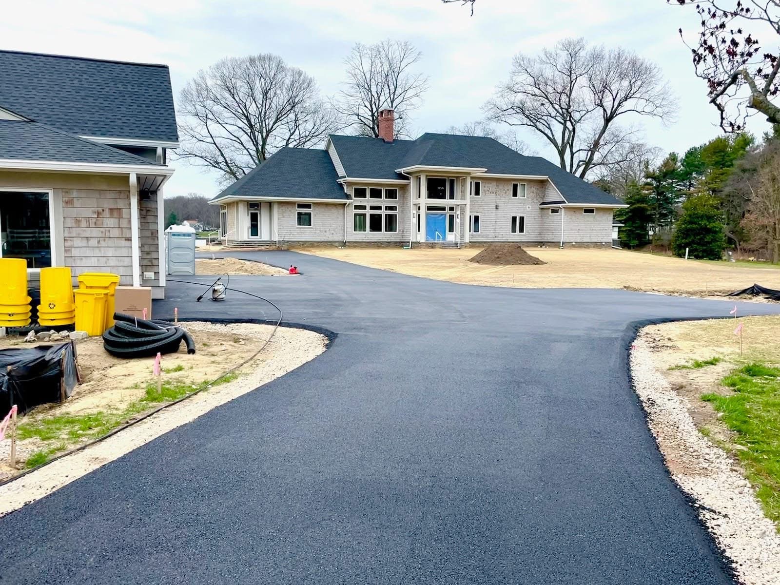 Freshly paved driveway in front of a new home